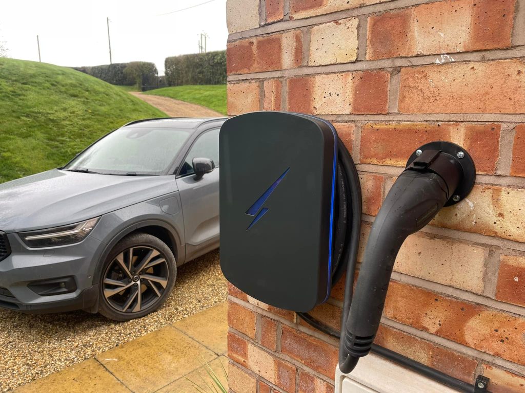 Completed home EV charger installation with electric car, installed by M J Wallace Limited, NICEIC-approved EV charger specialists in the UK